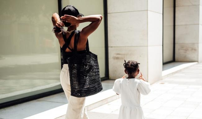 a woman walking with her child