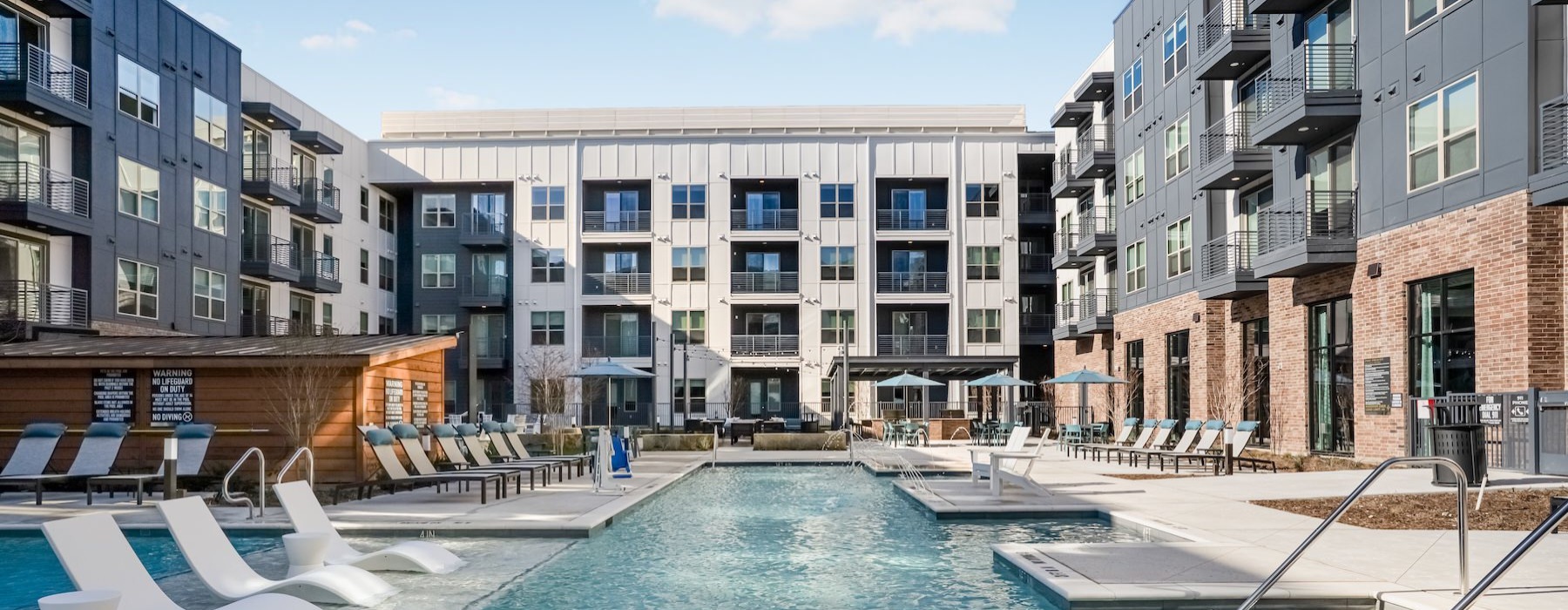 a swimming pool in a courtyard between buildings