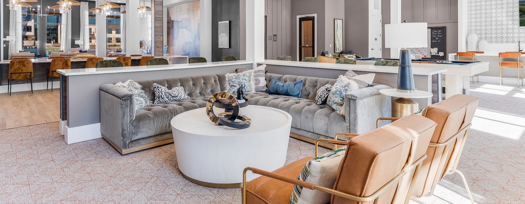 a clubhouse room with a couch, chairs and a coffee table