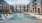a swimming pool in a courtyard between buildings