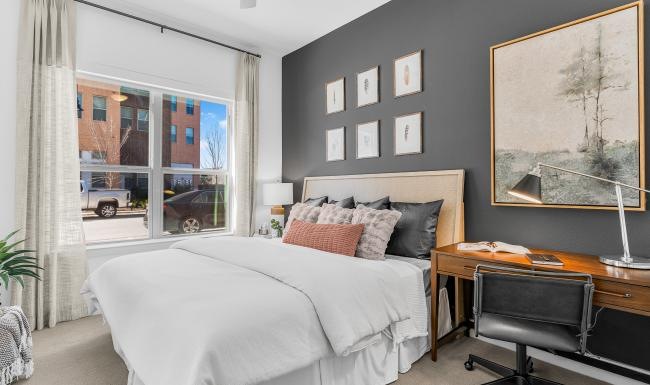 a bedroom with a bed and a large window