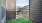 a gated yard with buildings in the background